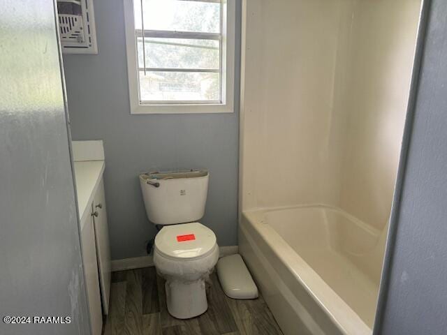 123 Lester St, Ville Platte, LA 70586 - bathroom featuring toilet, vanity, and hardwood / wood-style floors