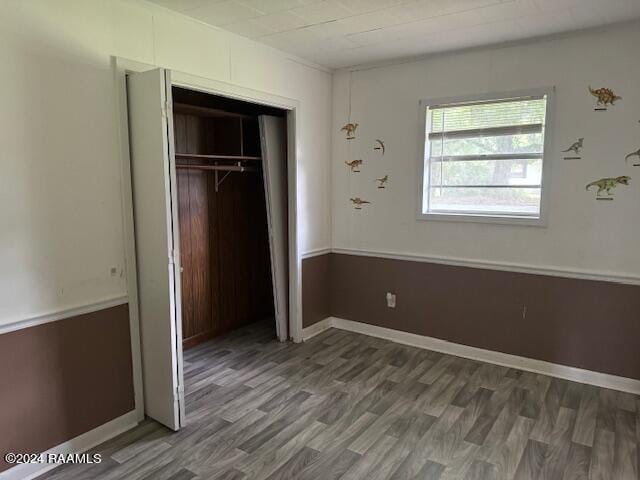 123 Lester St, Ville Platte, LA 70586 - unfurnished bedroom with wood-type flooring and a closet