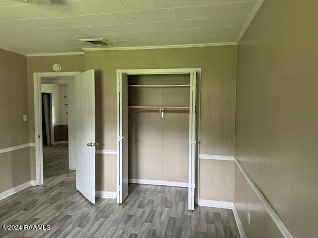 123 Lester St, Ville Platte, LA 70586 - unfurnished bedroom with hardwood / wood-style floors, a closet, and crown molding