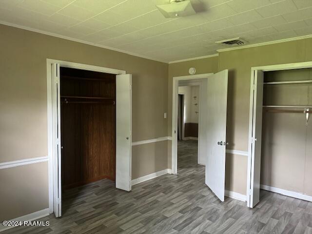 123 Lester St, Ville Platte, LA 70586 - unfurnished bedroom featuring wood-type flooring and crown molding