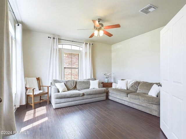 living room with ceiling fan and dark hardwood / wood-style flooring