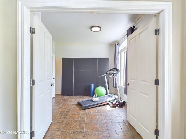 exercise area featuring crown molding