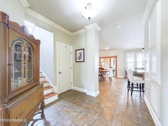 foyer with ceiling fan and crown molding