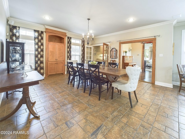 dining area with crown molding and an inviting chandelier