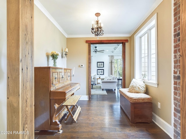 hall featuring dark hardwood / wood-style floors, an inviting chandelier, and crown molding