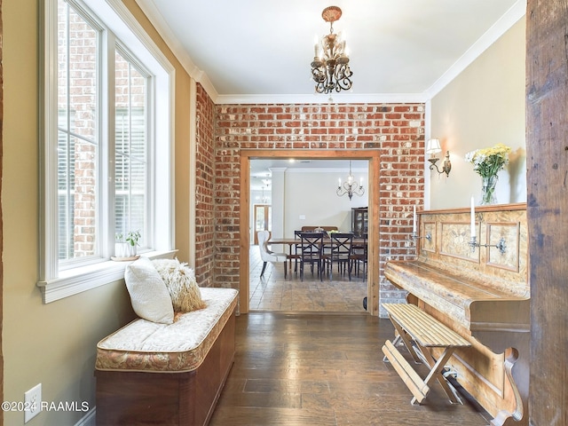 living area with a wealth of natural light, dark hardwood / wood-style flooring, a chandelier, and ornamental molding