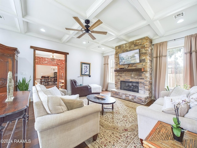 living room with coffered ceiling, hardwood / wood-style flooring, ceiling fan, a fireplace, and beamed ceiling