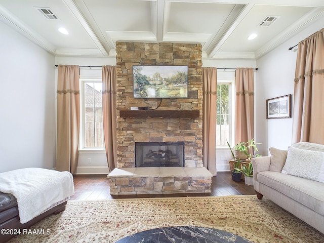 living room featuring a stone fireplace, a wealth of natural light, beamed ceiling, and dark hardwood / wood-style floors