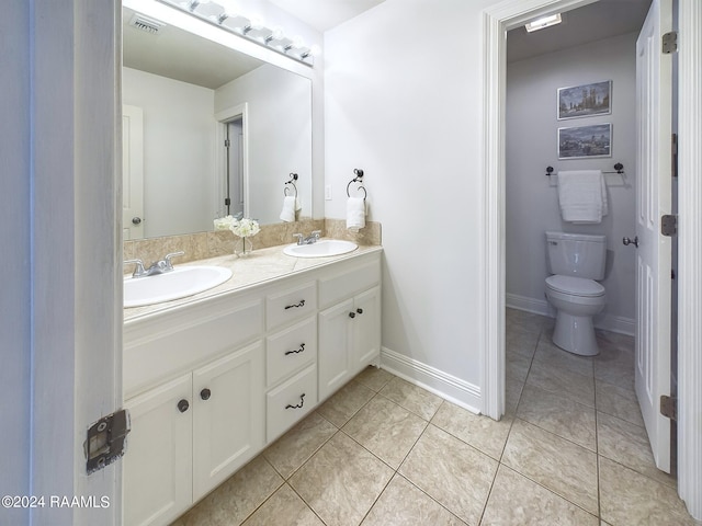 bathroom featuring tile patterned flooring, vanity, and toilet