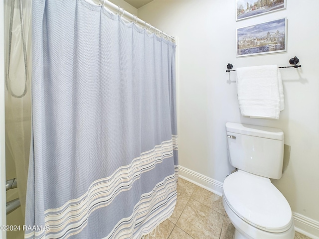 bathroom featuring tile patterned flooring and toilet