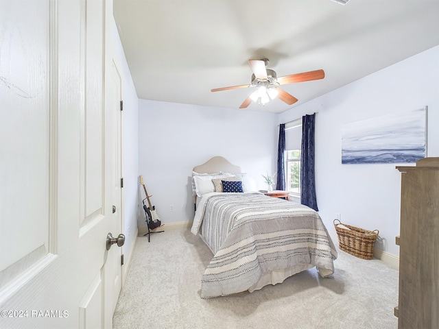 bedroom with light carpet and ceiling fan