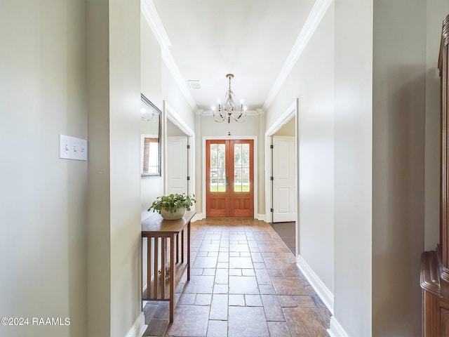 entrance foyer with french doors, a notable chandelier, and ornamental molding