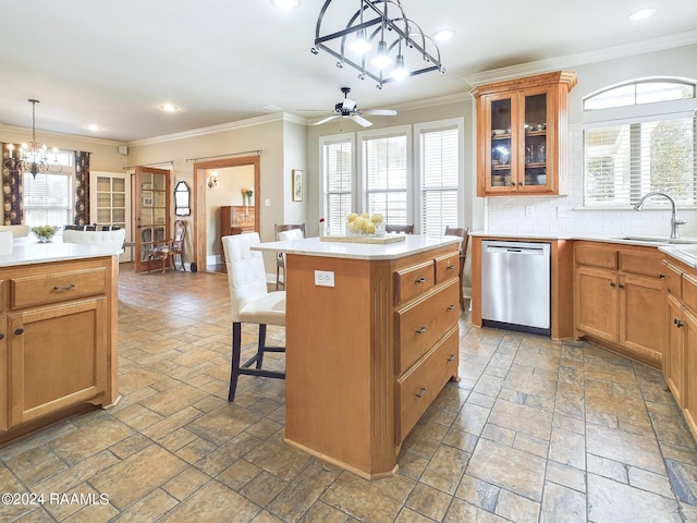 kitchen with stainless steel dishwasher, a center island, a healthy amount of sunlight, and backsplash