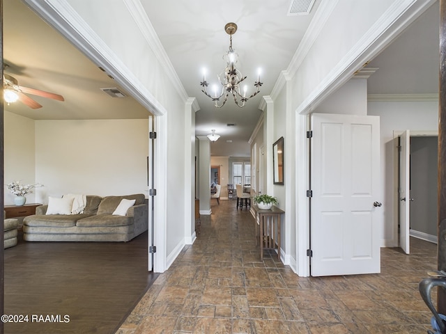 hall with a chandelier and ornamental molding