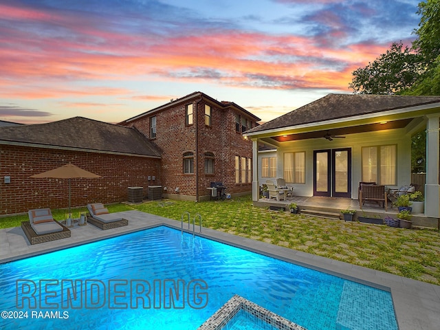 pool at dusk with grilling area, central AC unit, ceiling fan, and a lawn