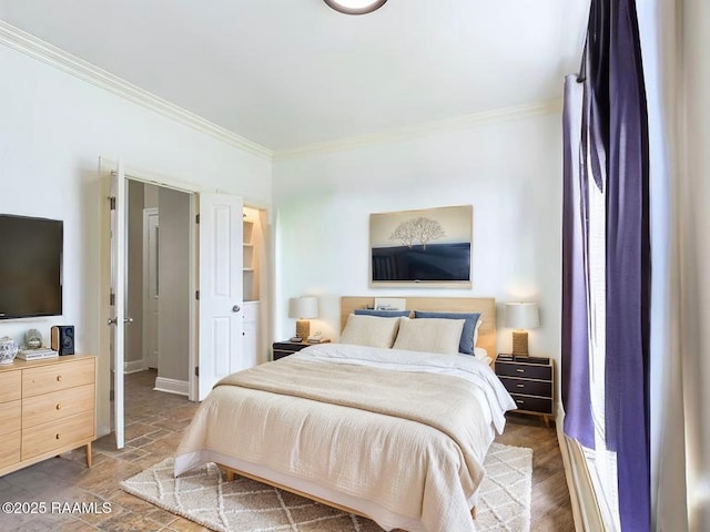 bedroom with baseboards, stone finish floor, and ornamental molding