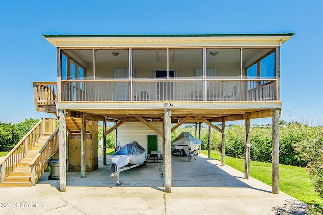 view of front of house with a sunroom and a carport