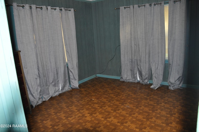 empty room with dark parquet flooring