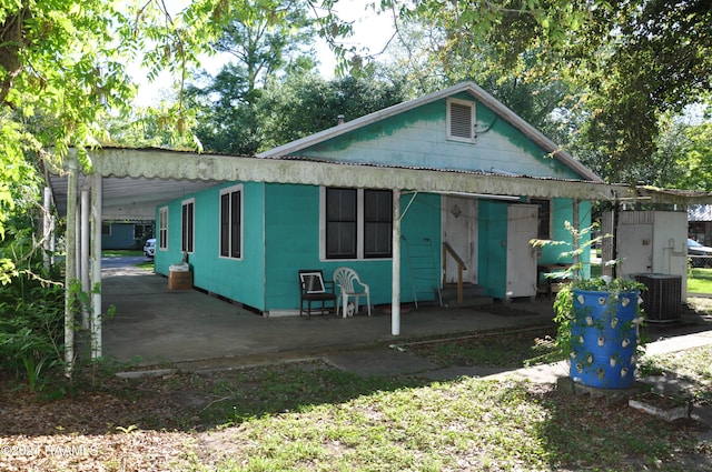 view of front of property with a carport and central air condition unit