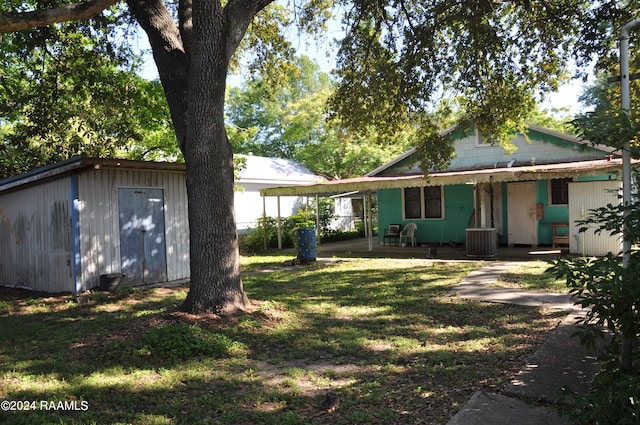 rear view of house featuring a carport and central AC unit