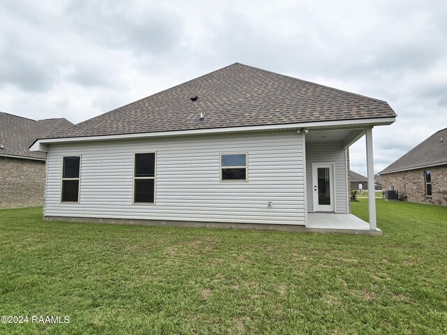 back of house featuring cooling unit, a yard, and a patio area