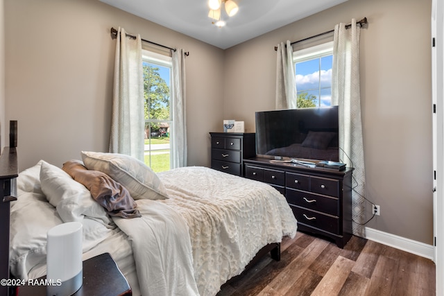 bedroom with dark wood-type flooring