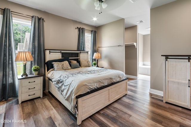 bedroom with ceiling fan, dark hardwood / wood-style flooring, and ensuite bath