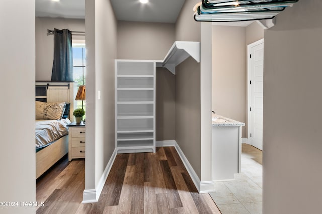 walk in closet featuring light hardwood / wood-style flooring