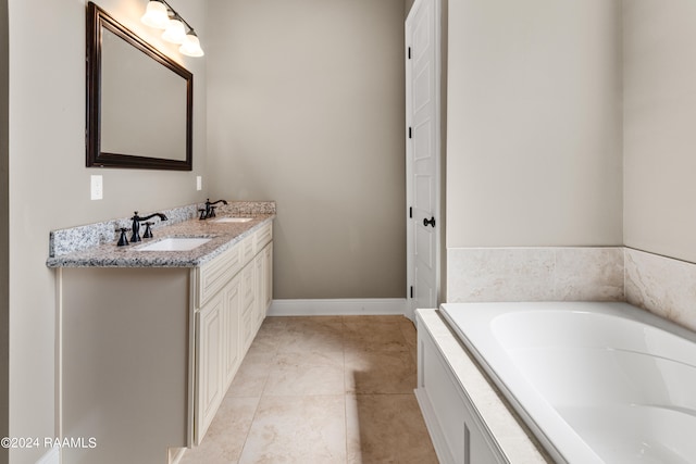 bathroom featuring double vanity, a washtub, and tile floors