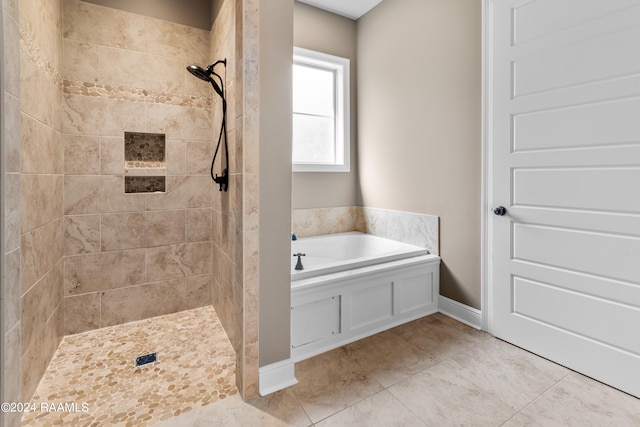 bathroom with tile floors and independent shower and bath