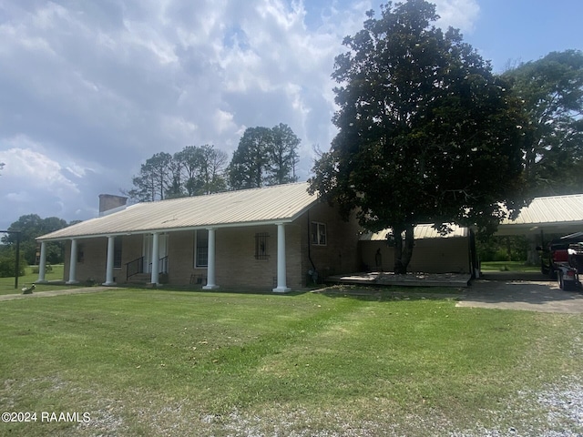 view of front of property with a chimney, metal roof, and a front yard