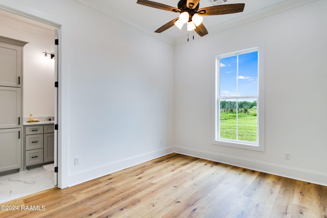 unfurnished bedroom with ceiling fan and light hardwood / wood-style flooring