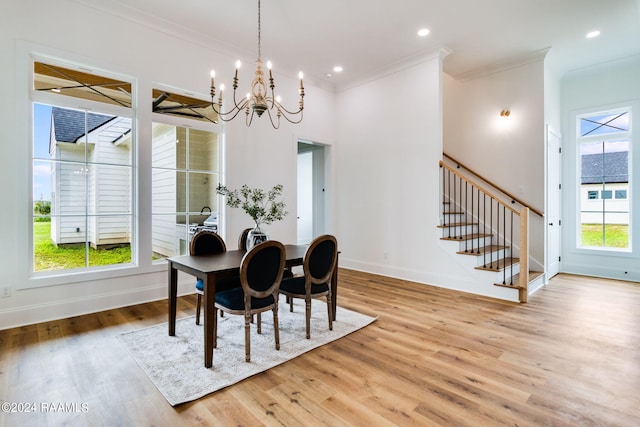 dining space featuring light hardwood / wood-style floors, crown molding, and a wealth of natural light