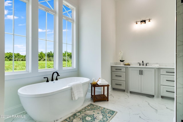 bathroom with vanity, tile floors, and a bathtub