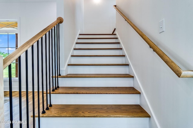 staircase featuring wood-type flooring