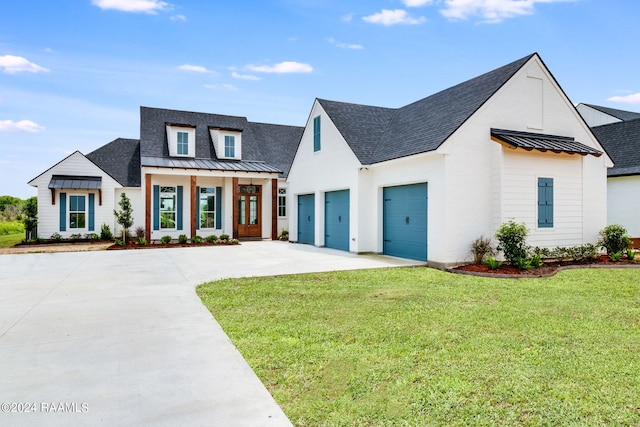 modern inspired farmhouse with a front yard and a garage