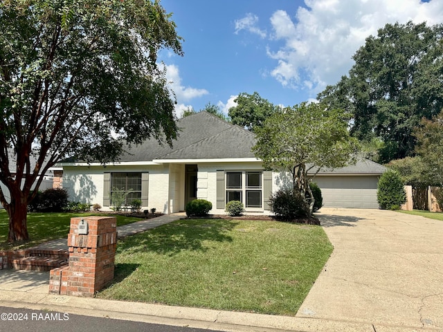 ranch-style home with a garage and a front yard