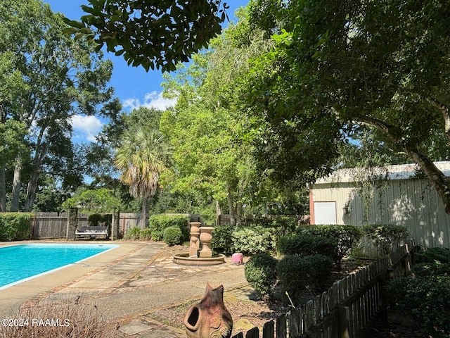 view of swimming pool featuring a patio area