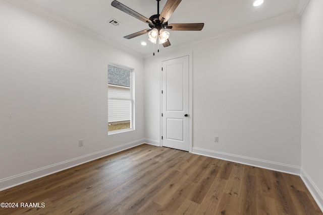 unfurnished room with dark hardwood / wood-style floors, ceiling fan, and crown molding