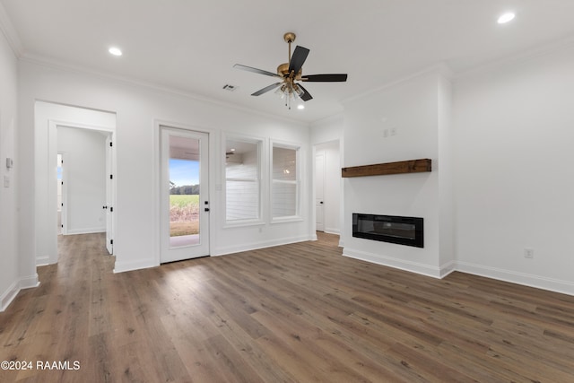 unfurnished living room with dark hardwood / wood-style flooring, ceiling fan, and crown molding