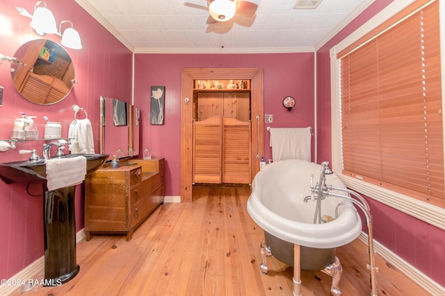 bathroom featuring a bathtub, ceiling fan, wood-type flooring, and crown molding