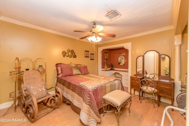 bedroom featuring light wood-type flooring, ceiling fan, and ornamental molding