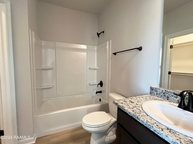 full bathroom featuring vanity, toilet, hardwood / wood-style flooring, and bathing tub / shower combination