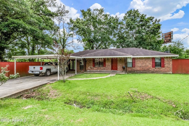 single story home featuring a front lawn and a carport