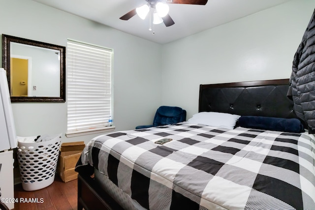 bedroom featuring multiple windows, dark wood-type flooring, and ceiling fan