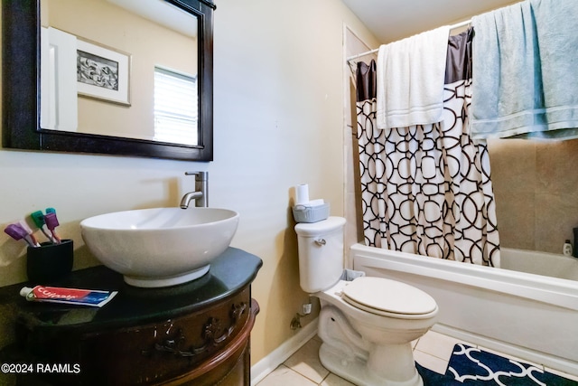 full bathroom with tile floors, shower / tub combo with curtain, vanity, and toilet