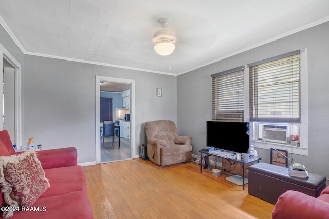 living room featuring wood-type flooring, cooling unit, ceiling fan, and crown molding