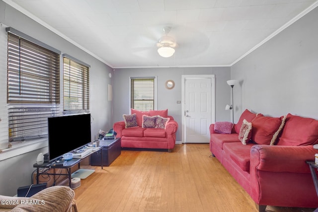 living room featuring hardwood / wood-style floors, a healthy amount of sunlight, and crown molding