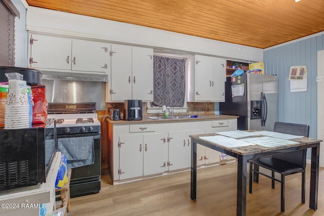 kitchen with white cabinets, stainless steel fridge, black electric range oven, and light hardwood / wood-style floors