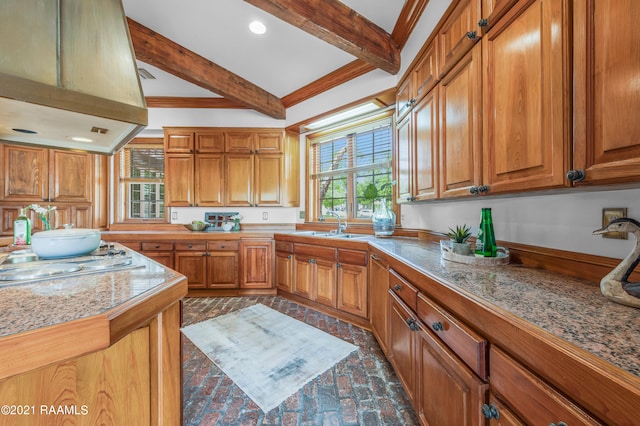 kitchen with crown molding, beamed ceiling, premium range hood, stainless steel gas stovetop, and sink